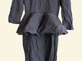 grey dress on a hanger in front of a white background