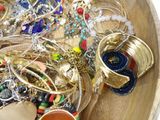 a wooden bowl filled with lots of different colored bracelets