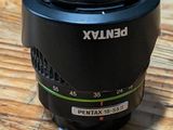 a camera lens on a wooden table with a blurry background