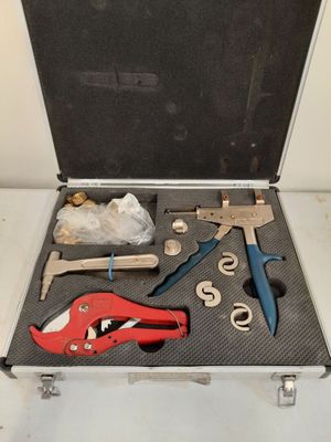 a suitcase with tools in it sitting on a table