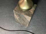 a lamp that is sitting on a block on the floor
