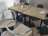 a table and chairs in a room with a black and white checkered floor