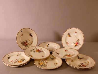 a pile of plates with birds on them on a table