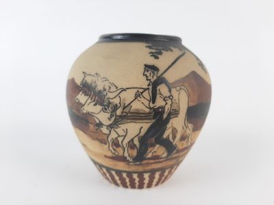 a vase with a picture of a man riding a horse on it