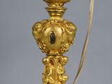 a gold lamp that is sitting on a table