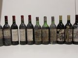 several bottles of wine are lined up in a row on a table