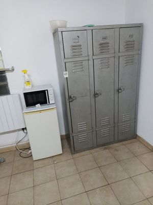 two lockers in a room with a microwave and a microwave oven