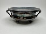 a metal bowl with a handle on a white surface