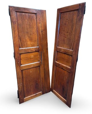 two wooden doors with one open and the other closed