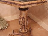 a small table with a vase on top of it