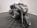 a motorcycle that is parked on a checkered floor