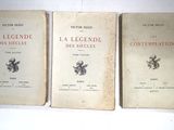 three books sitting on top of a white table next to each other