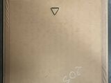 painting of a triangle on a cardboard box with a sticker on it