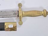 a gold and black sword on a white surface