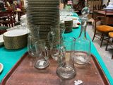 many plates and glasses sitting on a tray on the table