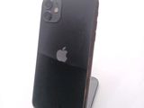 a black iphone sitting on a stand on a white surface
