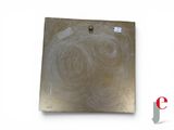 a picture of a piece of metal on a white surface