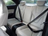 two seats in the back of a car with a black seat belt