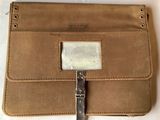 leather wallet with a metal buckle on the front and a metal clasp on the back