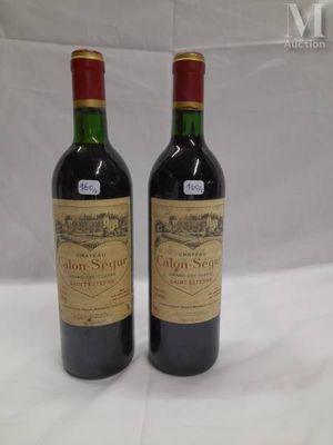 two bottles of wine sitting on top of a white table