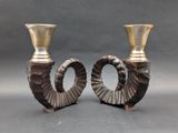 two silver vases sitting next to each other on a table