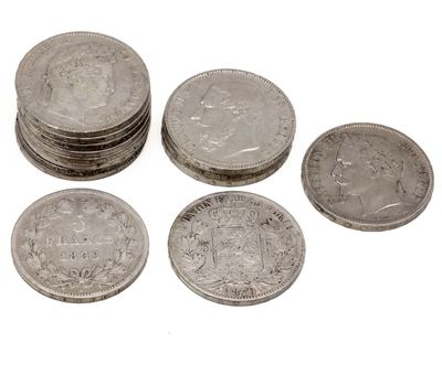 several coins are stacked on top of each other on a white surface