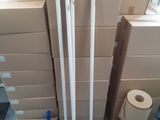 a stack of boxes and brooms on the floor in a room