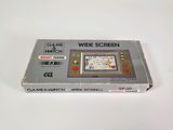 an old nintendo game console sitting on top of a white table