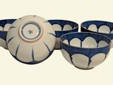 four bowls and a bowl sitting on a table