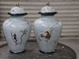 two vases that are sitting on a table