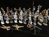 many figurines of soldiers on a black background