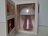 a box with a lamp inside of it on a table