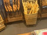 baskets of bread and pastries are on display in a bakery