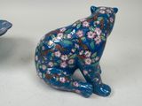 two ceramic animals sitting next to each other on a table