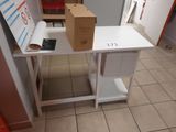 a white table with a box on it and a phone on it