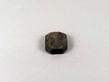 a close up of a small metal object on a white surface
