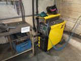 a welding machine that is sitting in a garage