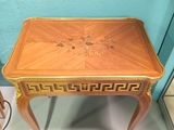 a small table with a wooden top on display