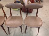 three chairs in a room with a lot of furniture in the background