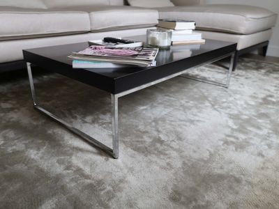 a coffee table with magazines on top of it in a living room