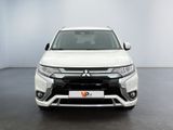 the front view of a white suv parked in a room
