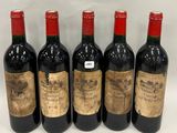 six bottles of wine are lined up in a row on a white surface
