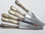 five knives that are sitting next to each other on a table