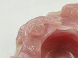 a close up of a pink object on a white surface