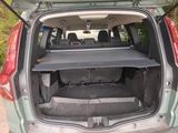 the back of a car with its trunk open and a table in the trunk