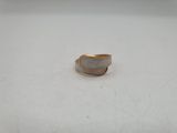 a close up of a ring on a table with a white background