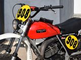 a red and black motorcycle with a number plate on it