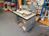 an image of a workbench with a computer on it in a warehouse