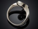 a close up of a silver ring on a black surface