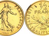 a close up of a gold coin with a woman on it